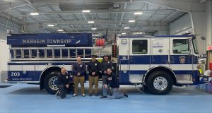 staff pose with their brand new fire truck